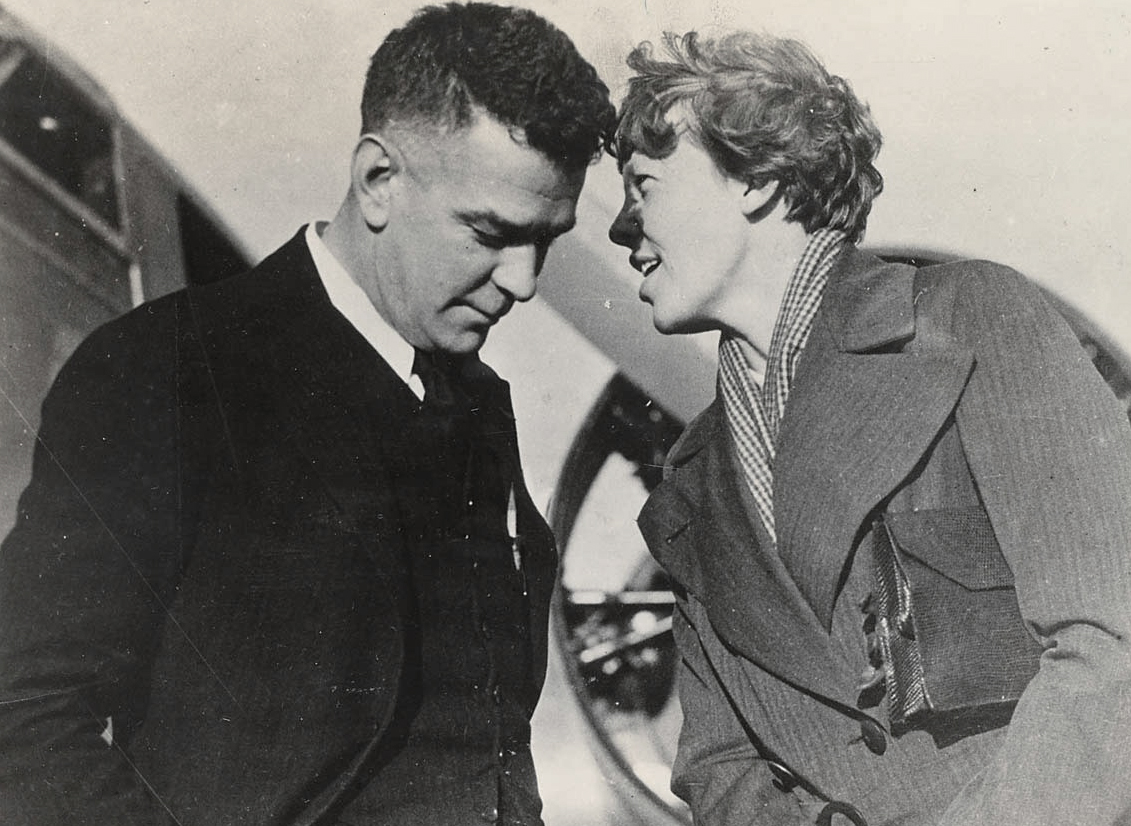 Amelia Earhart speaking with Charles Ulm at Oakland Airport in 1934.