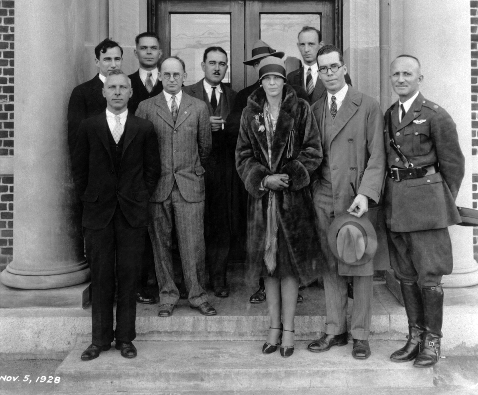 Amelia Earhart with staff on the steps of the Langley Research Building in 1928.