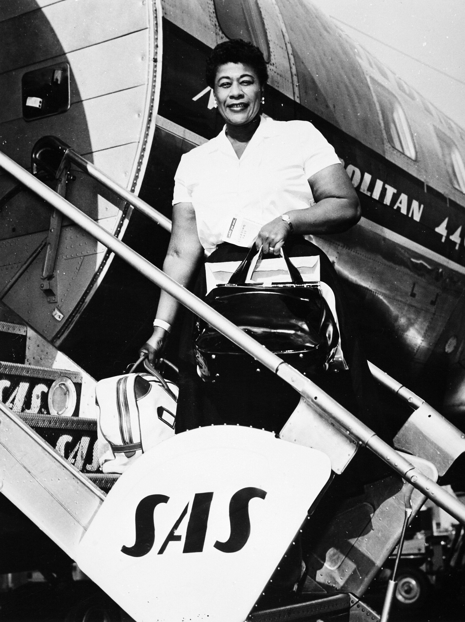 Ella Fitzgerald disembarking from a Convair 440 aircraft.