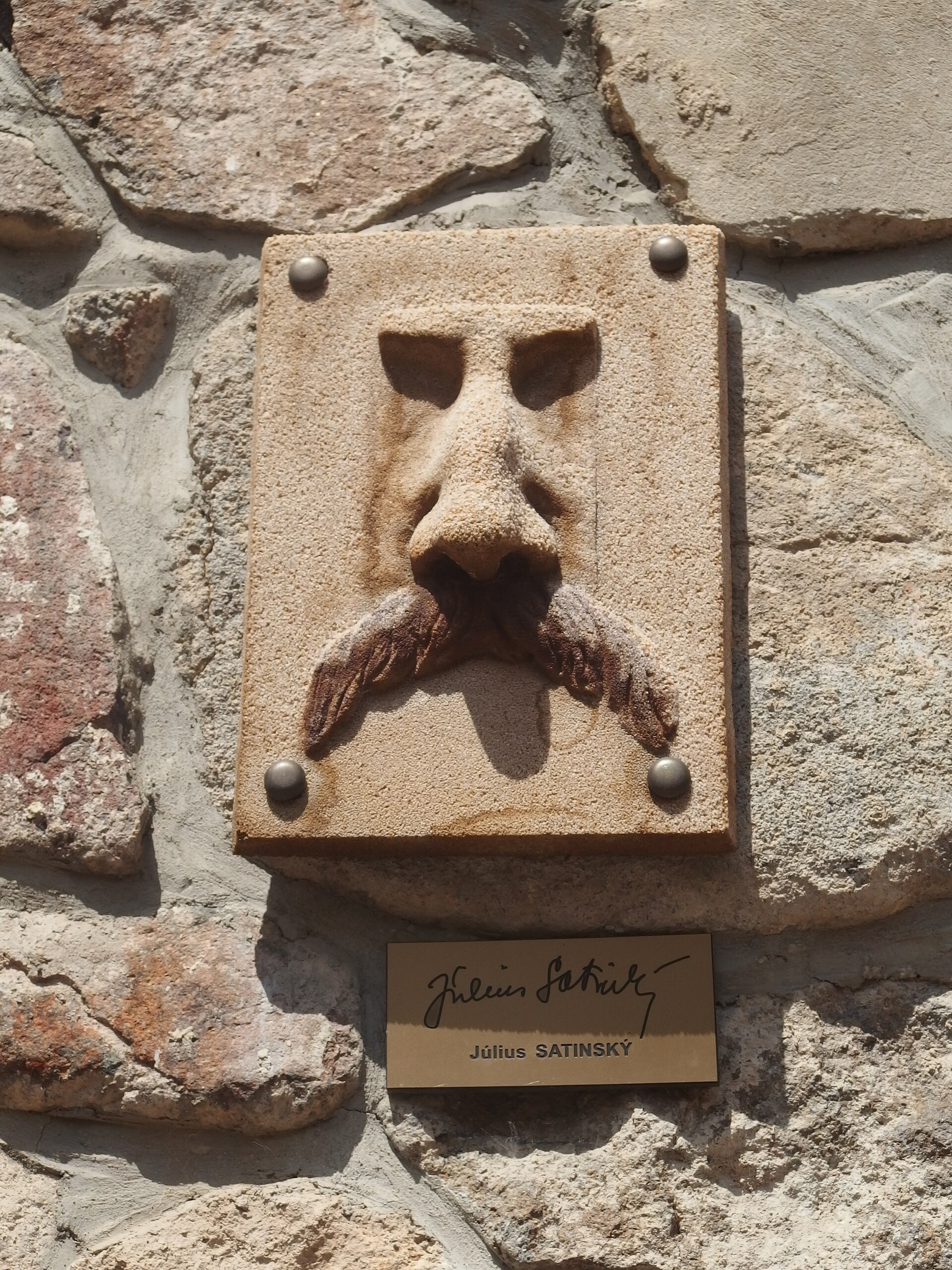 A relief of Július Satinský's nose in the Alley of Famous Noses in Kremnica. — Palickap, CC BY-SA 4.0 (Wikimedia Commons)