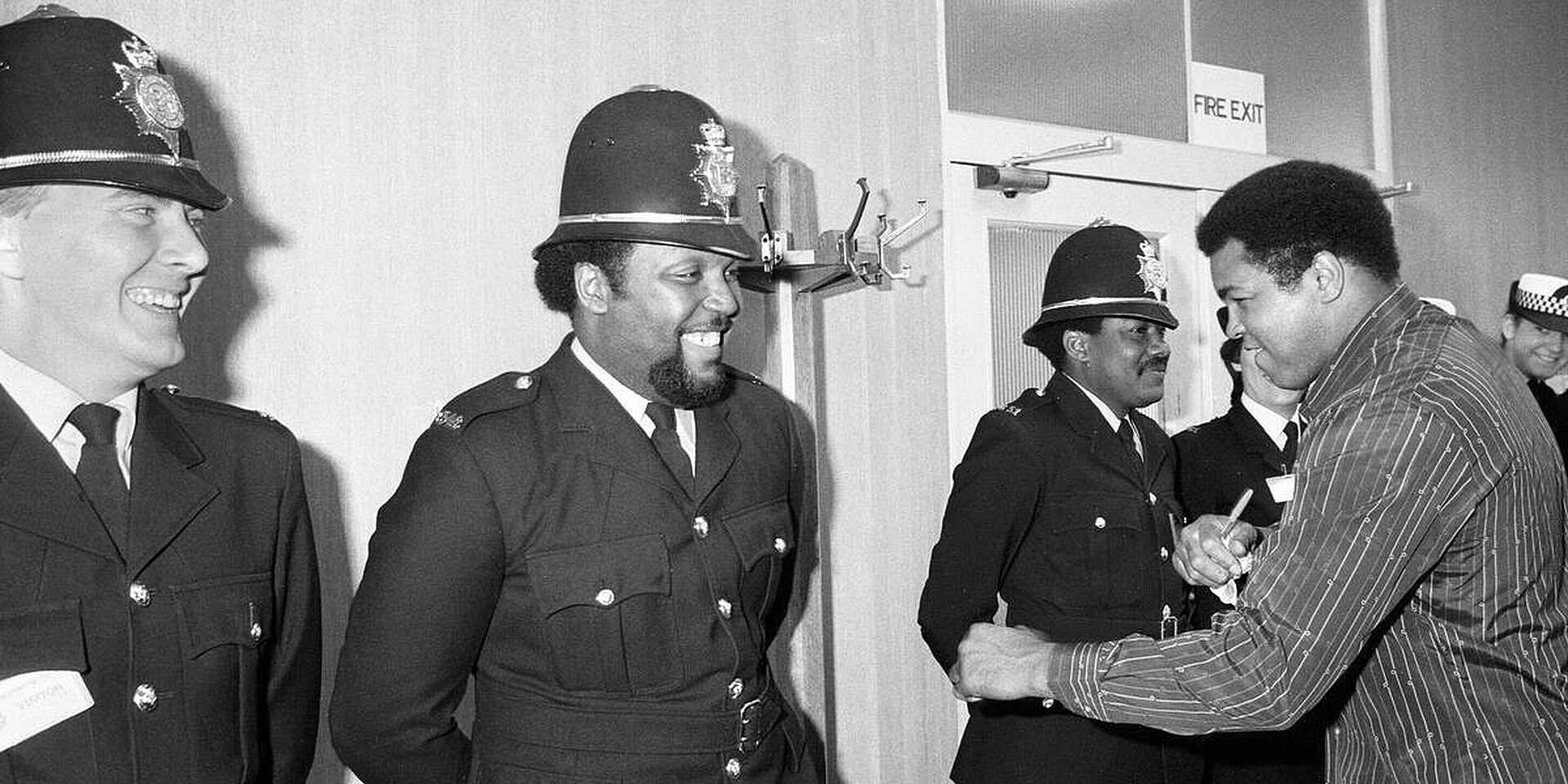 Muhammad Ali visiting police officers in 1983. — West Midlands Police from West Midlands, United Kingdom, CC BY-SA 2.0 (Wikimedia Commons)