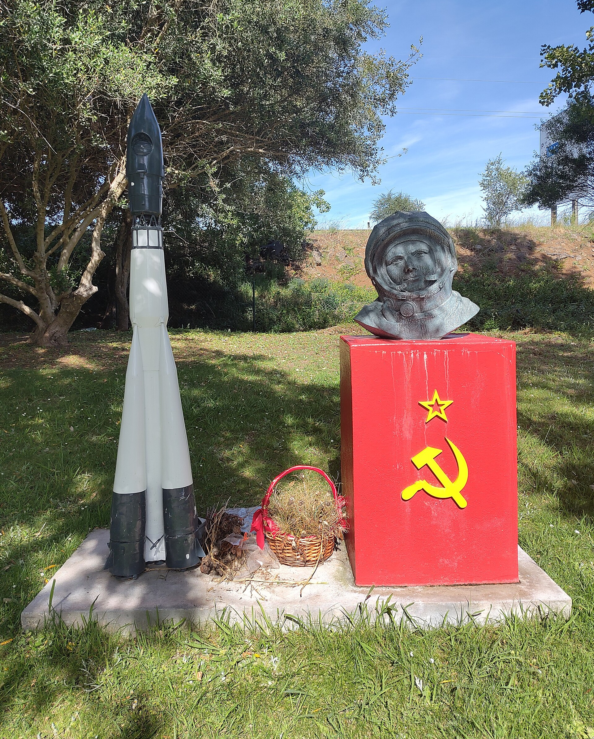 A bust of Yuri Gagarin beside a model of the Vostok 1 rocket at Tagus Park.